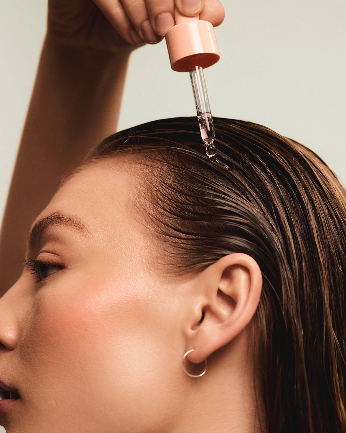 Model using Head & Hair Heal scalp serum for itchy and dry scalp