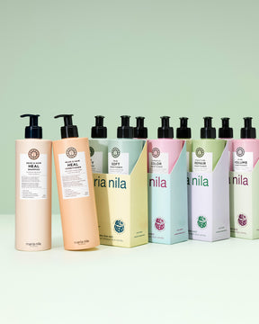 Row of Nila hair care products on a light green background