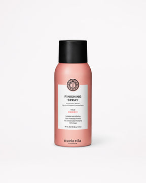 Pink hair spray bottle with black cap on a white background