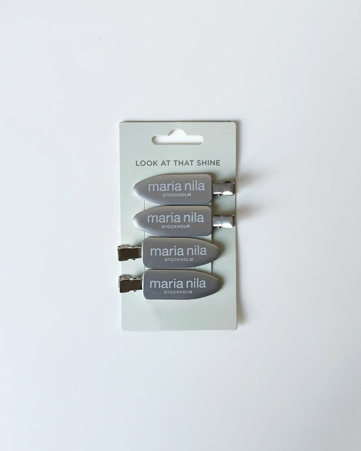 Set of Maria Nila hair clips on a white background