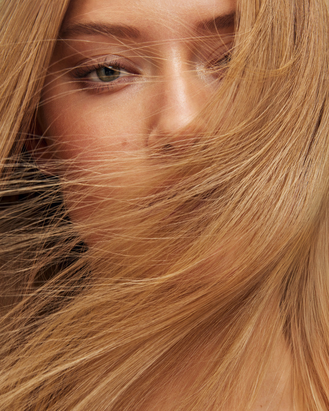 Model with dark blonde hair and green eyes